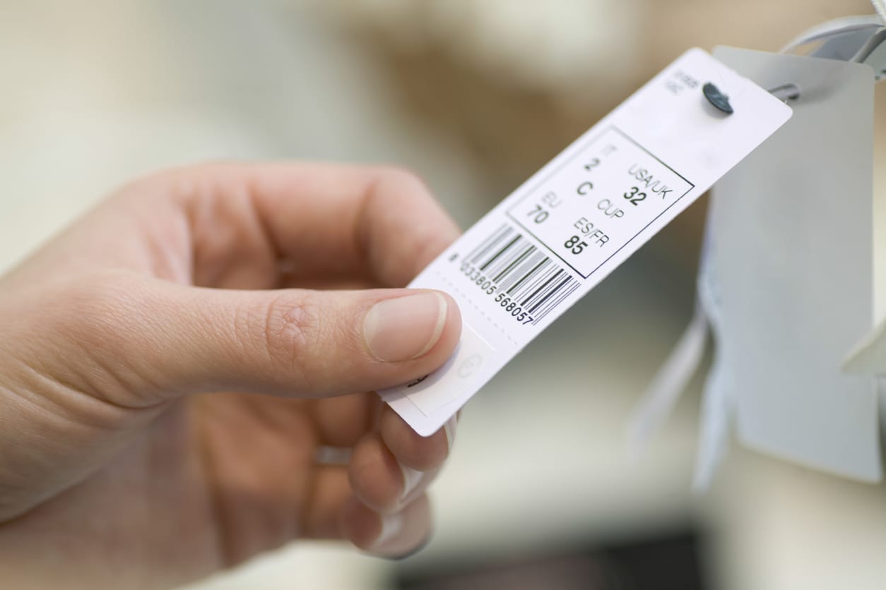 Looking at a barcode on a clothes tag in shop