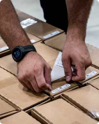 A man sticking a label on a parcel
