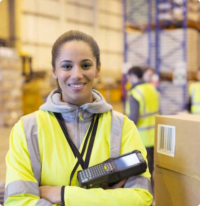A women smiling at the camera in a visibility jacket