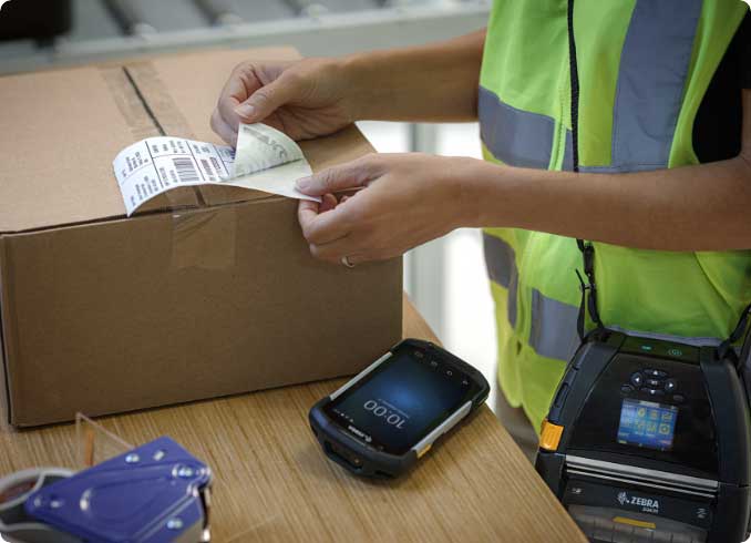 A man peeling off a barcode from a sticker