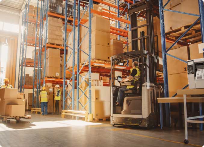 A warehouse operative working on a forklift